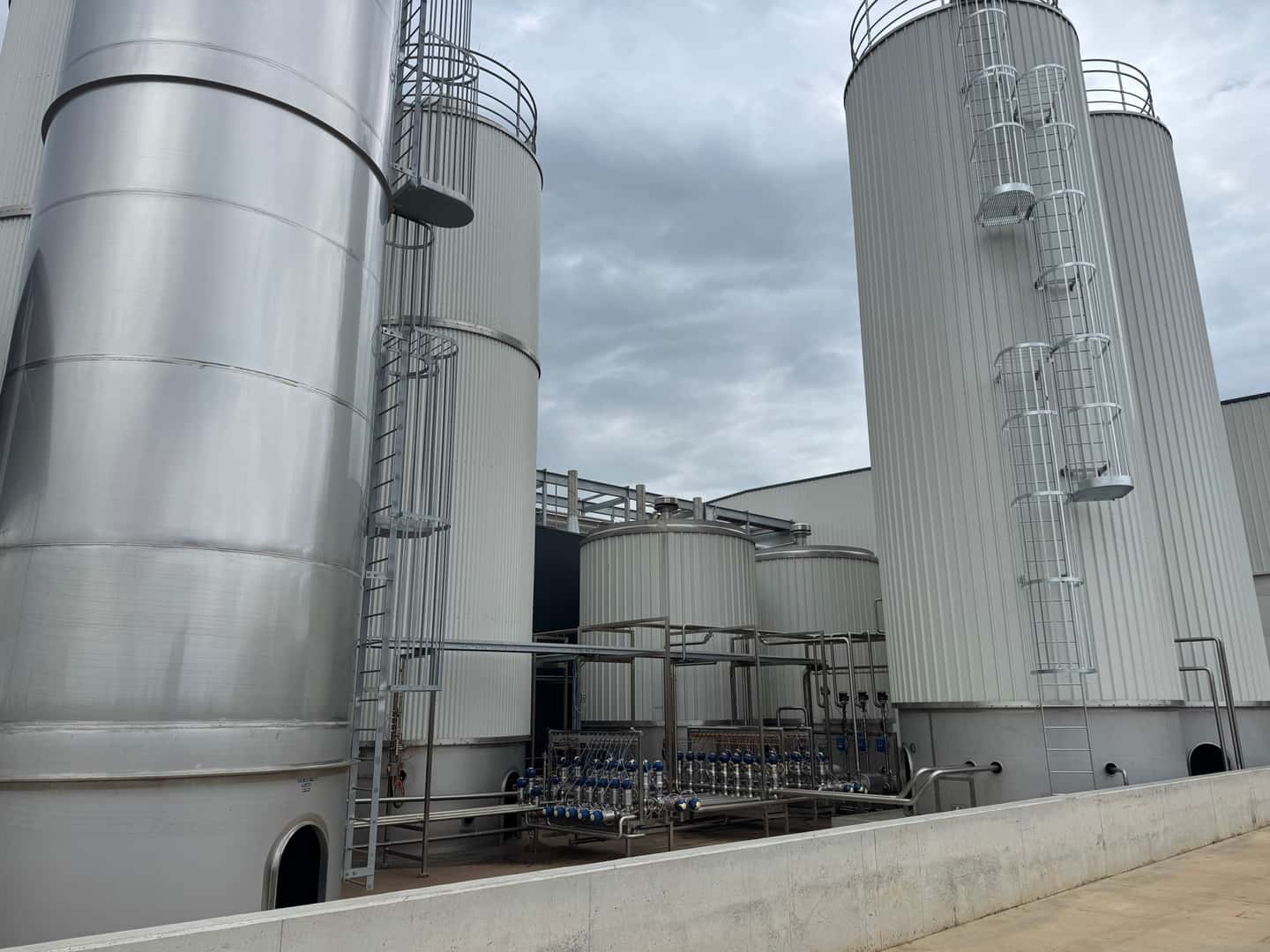 Food and beverage manufacturing facility with large stainless steel processing tanks